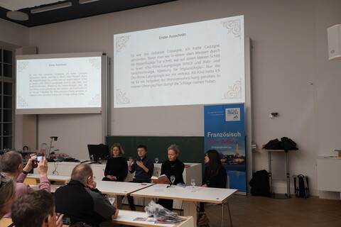 Vortragende bei der Lesung mit projiziertem Text